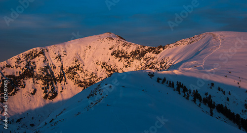 Peak Cherskogo illuminated rays of spring sun photo