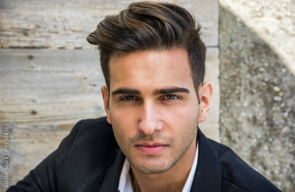 Attractive young man's headshot in urban setting Attractive young man's headshot in urban setting