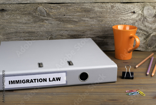 Immigration Law - folder on wooden office desk