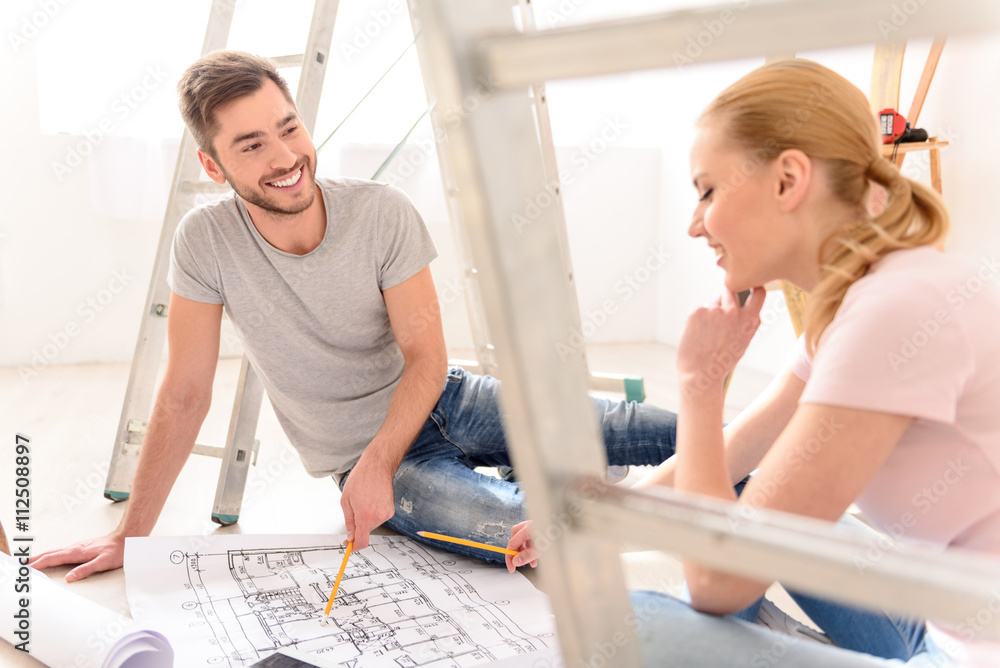 Young couple discussing apartments plan Young couple discussing apartments plan