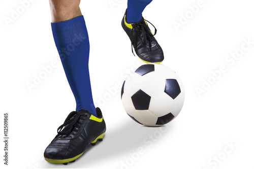 Legs of soccer player with ball