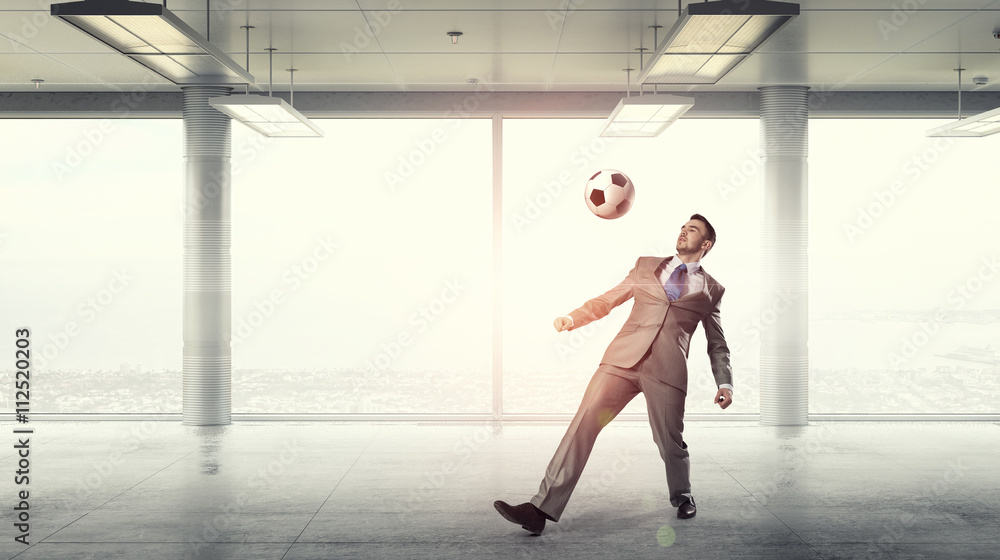 Fototapeta premium Playing football in office