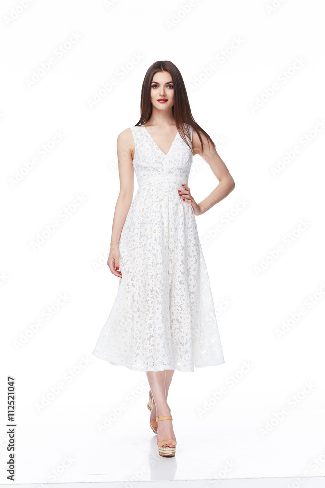 Young beautiful female model in white dress on white background