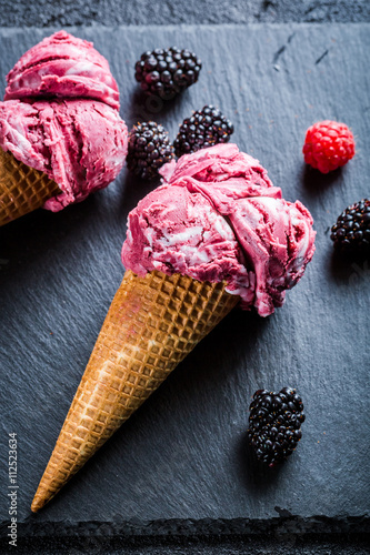 Tasty ice cream with berry fruits and mint leaves