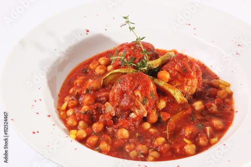 Zucchini in a red sauce with nuts, chickpeas