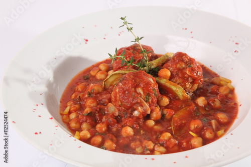 Zucchini in a red sauce with nuts, chickpeas
