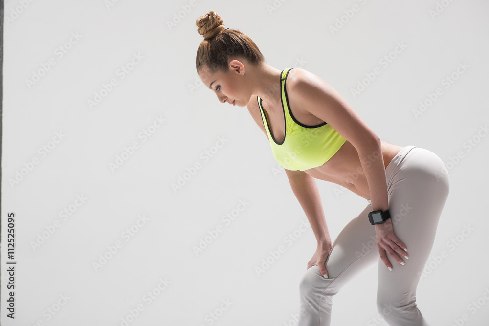 Skillful female runner stands in starting position Skillful female runner stands in starting position