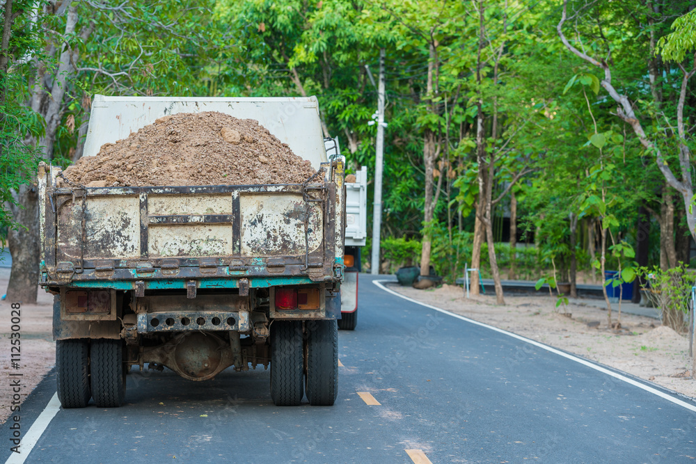 backside of Dump Truck with soil freight on tarmac road