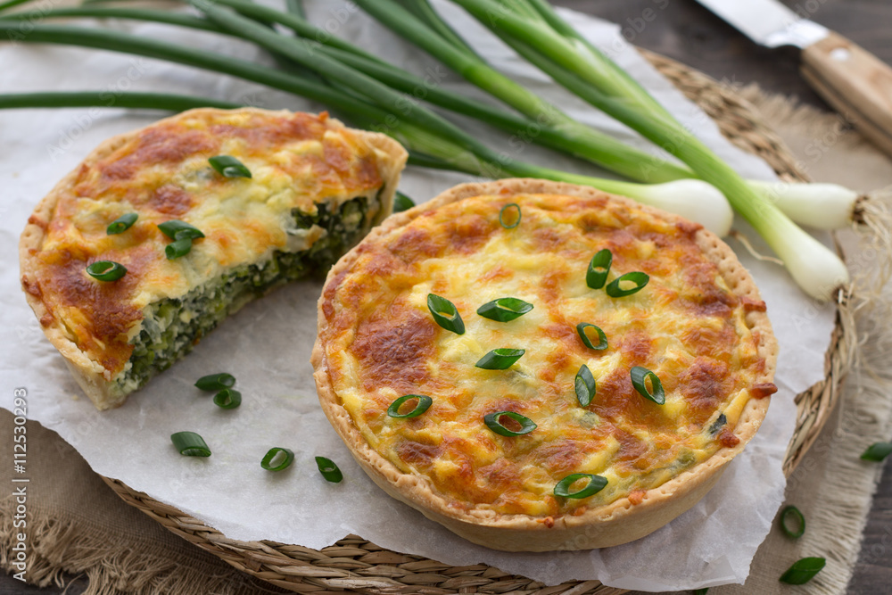 Mini quiche with green onions and cheese on a wooden background Mini quiche with green onions and cheese on a wooden background