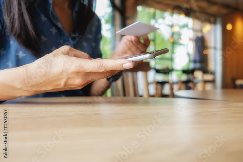 ..Beautiful young asian woman using smartphone and holding card for shopping online payment . Shopping concept with copy space. Online shopping concept. .