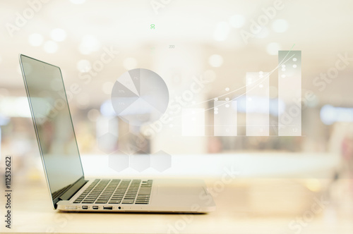 Abstract Blur Financial graph with laptop background
 photo