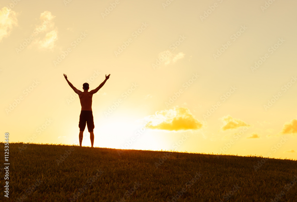 Young man with arms up in the air feeling happy and free. Young man with arms up in the air feeling happy and free.