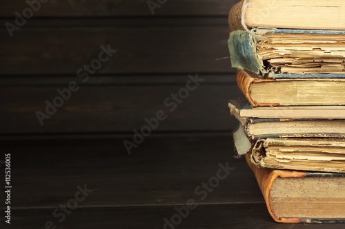 Front view of old books stacked on a shelf. Books without title and author. Old books in the university library. Books to study. Preparation for the exam in college.
 photo