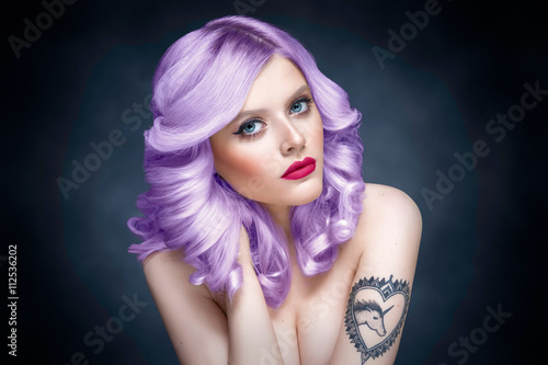 Studio beauty portrait of a girl with purple hair