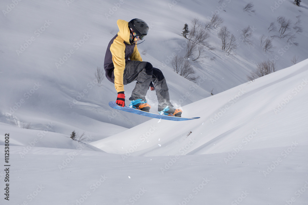 Snowboard rider jumping on mountains. Extreme snowboard freeride sport. Snowboard rider jumping on mountains. Extreme snowboard freeride sport.