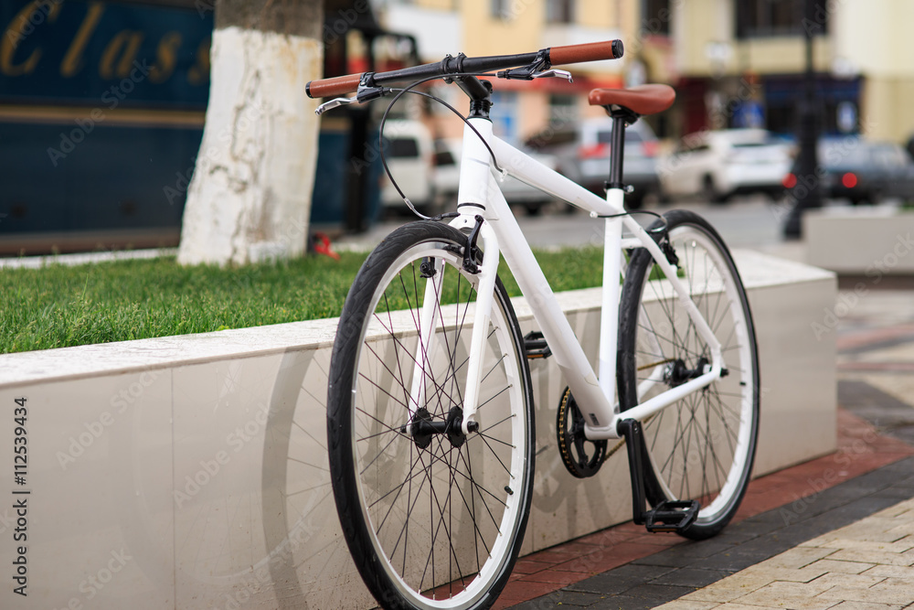 white fixed-gear bicycle on street