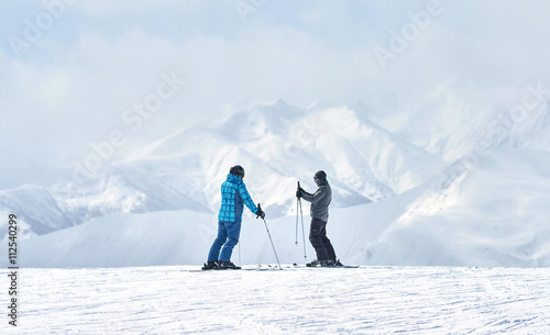 Fotografie two skiers talking about something alone