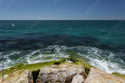 The waves beat against the rocks on the shore of the Atlantic Ocean.