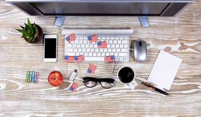 Top view of full desktop with small USA flags for the holidays