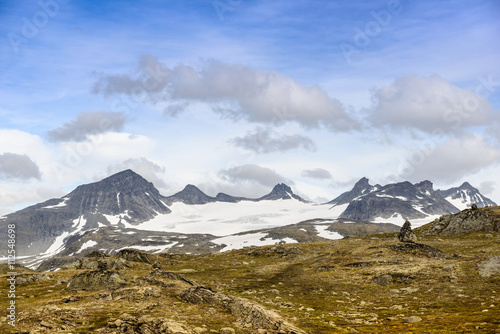 Fototapeta Naklejka Na Ścianę i Meble -  View of the glacier Galdhøpiggen from road No. 55. National Park Jotunheimen, Norway. National Tourist Routes in Norway.