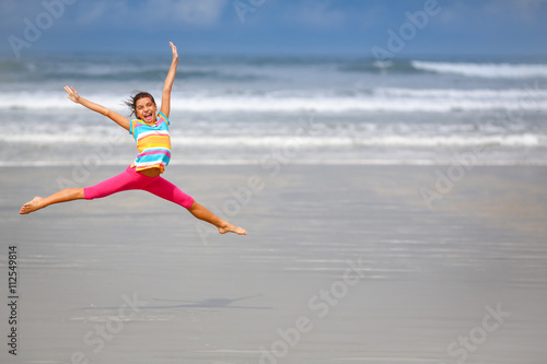 Girl jumping on the beach