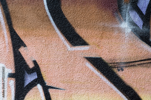 Detail of a graffiti art on a wall. Wall painted in different colors. Abstract colorful background.