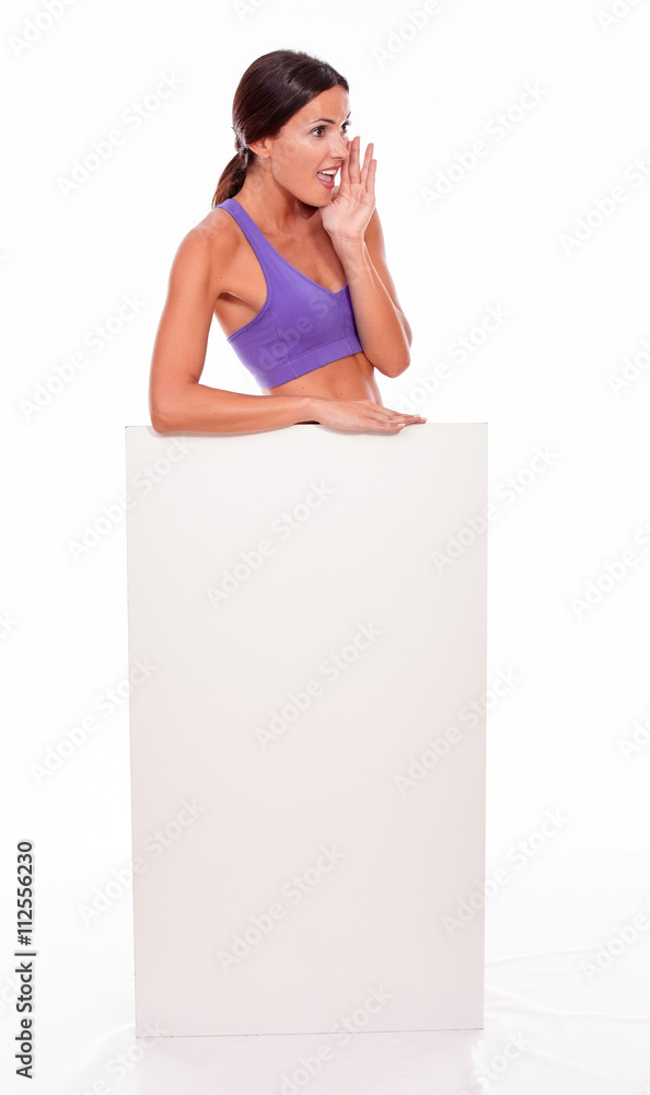 Healthy shouting brunette behind blank placard Healthy shouting brunette behind blank placard