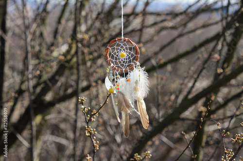 Handmade native american dream catcher on background of rocks an