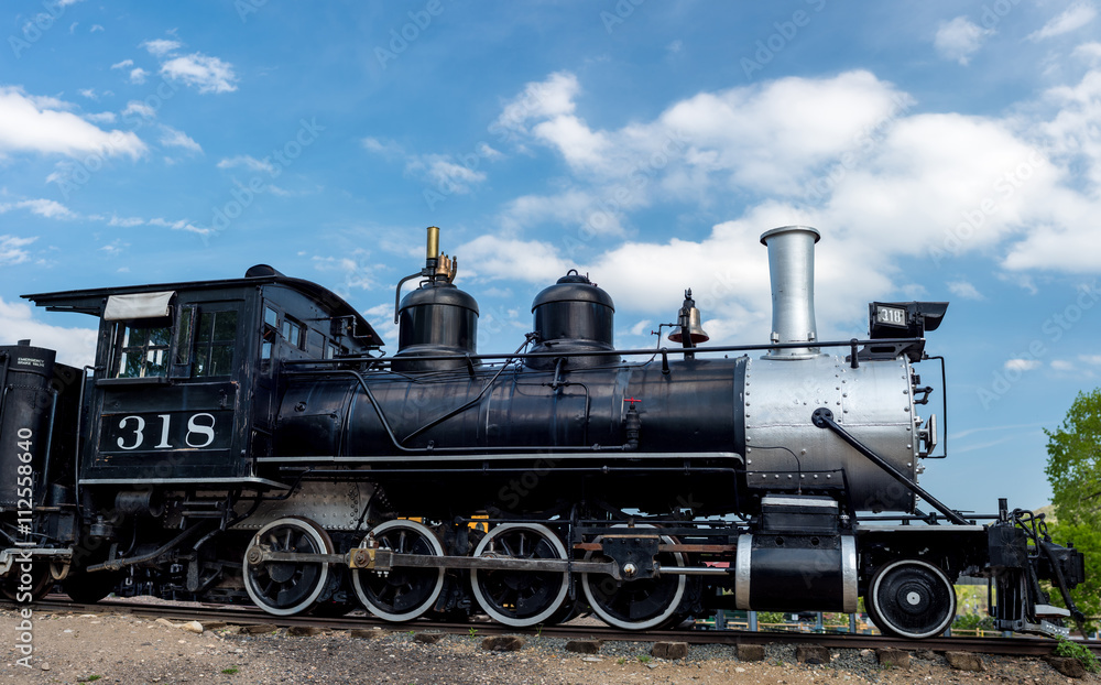 Obraz premium Steel black train engine on tracks