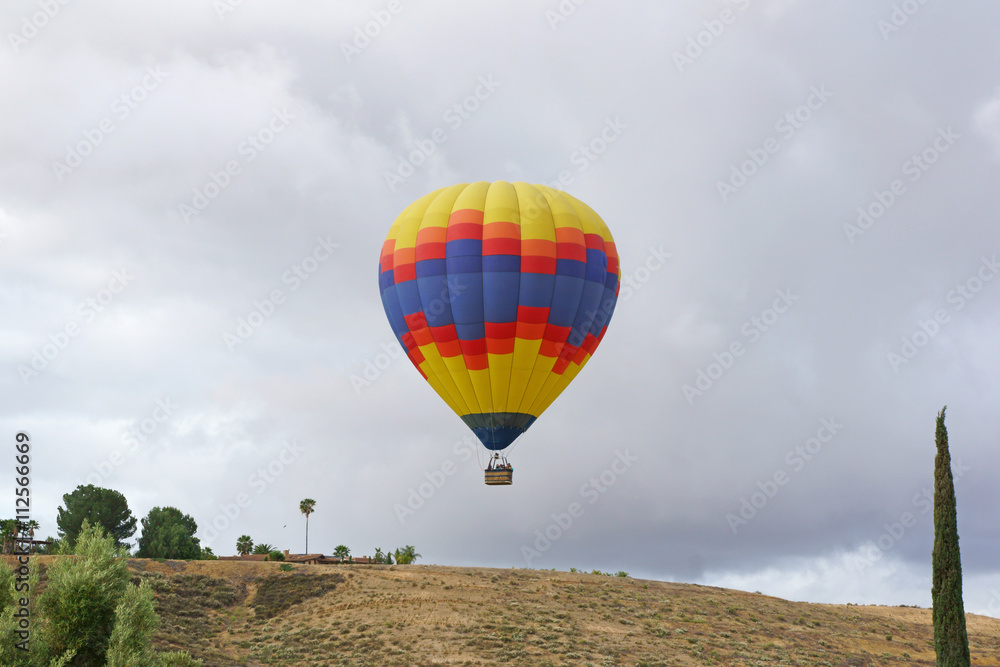 Fototapeta premium Balloon launch over hill during spring morning