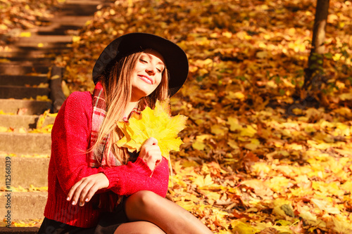 Woman relaxing in autumn fall park