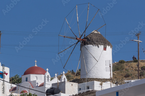 White windmill and church in town of Mykonos, Cyclades, Greece