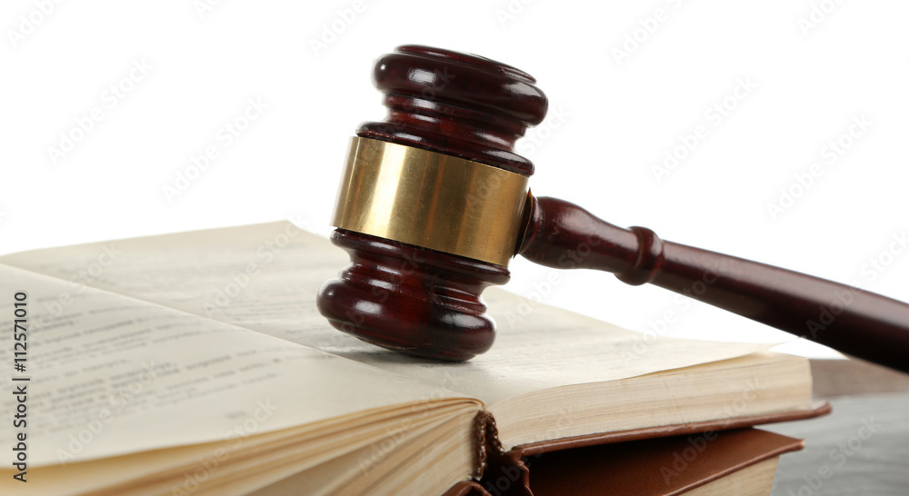 Gavel and books on wooden table on white background