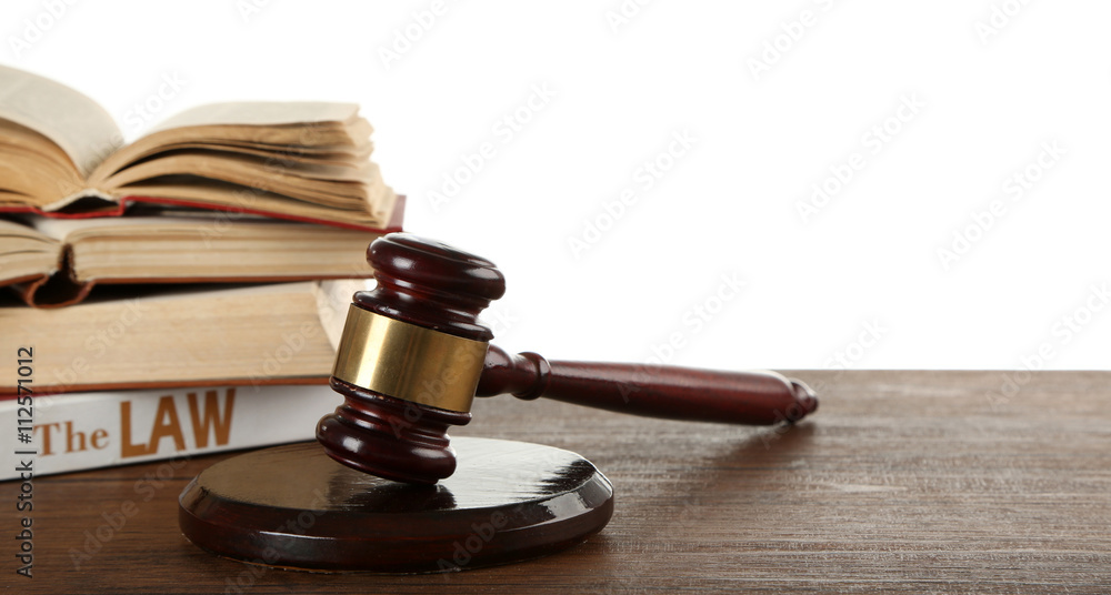 Gavel and books on wooden table on white background