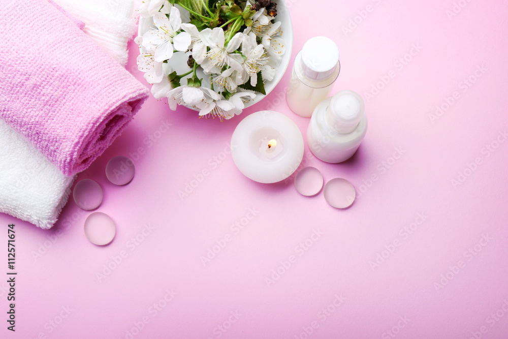Spa treatment with blooming branch on pink background Spa treatment with blooming branch on pink background