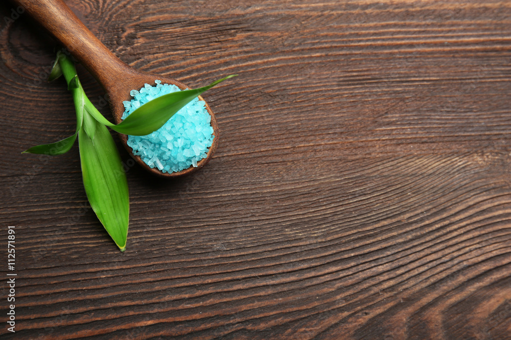 Spoon with sea salt on wooden background Spoon with sea salt on wooden background