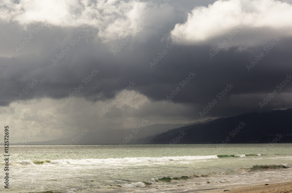 Pacific ocean during a storm. Beach landscape in the U.S. in bad weather. The ocean and waves during strong winds in United States, Santa Monica. Pacific ocean during a storm. Beach landscape in the U.S. in bad weather. The ocean and waves during strong winds in United States, Santa Monica.