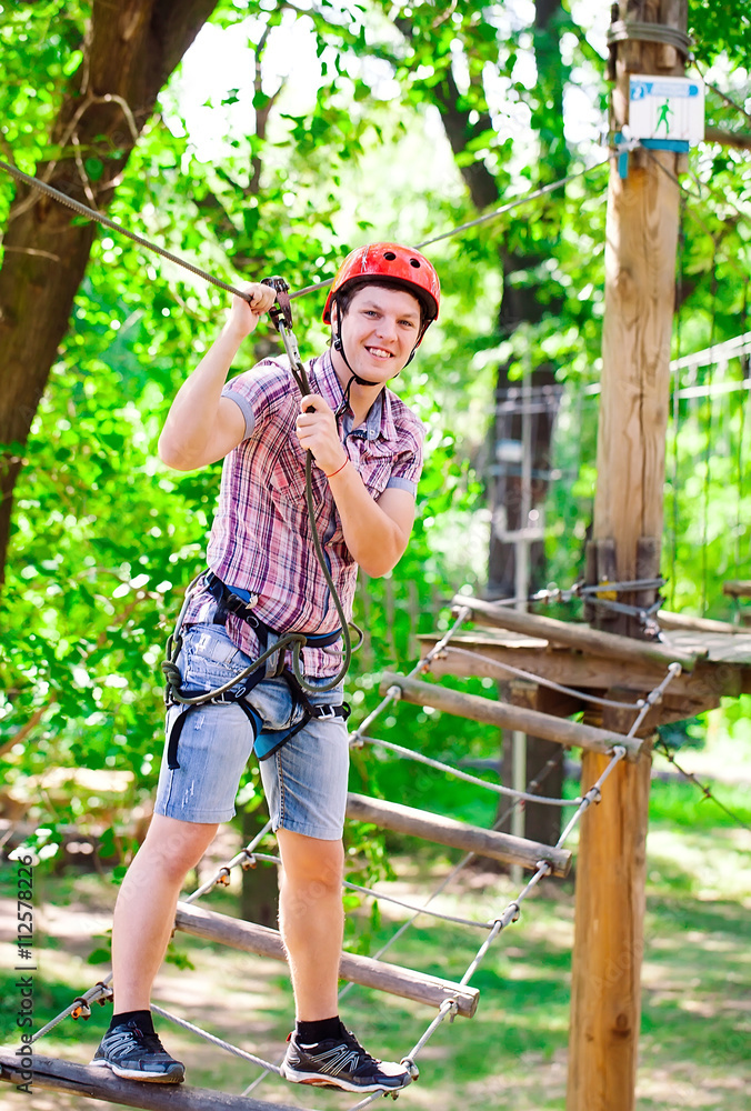 adventure climbing high wire park - people on course in mountain adventure climbing high wire park - people on course in mountain