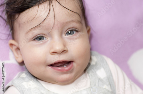 Portrait of little girl close up. Six-month old baby making funny faces.  © nadezhdaabramian