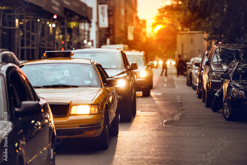 Car traffic on New York City street at sunset time © Nick Starichenko