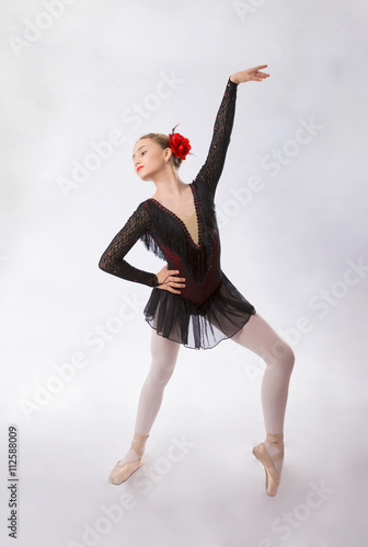 Ballerina in  black is dancing on a white background