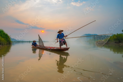 Fishermen in action when fishing in the mekong river   Thailand.