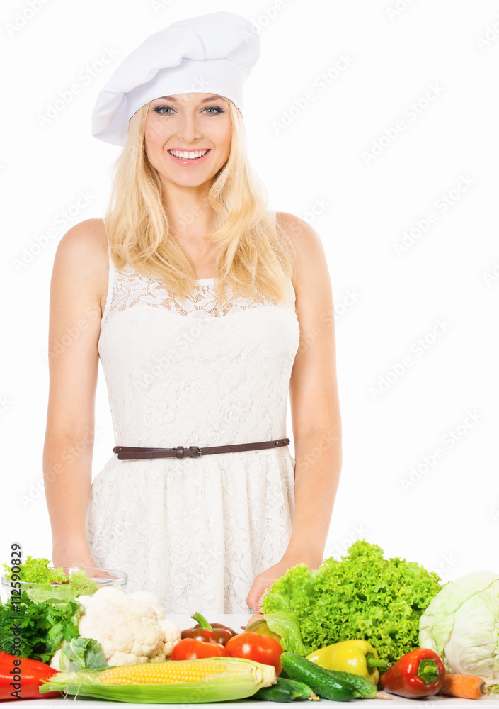 Woman in chef hat with fresh vegetables, isolated on white background Woman in chef hat with fresh vegetables, isolated on white background