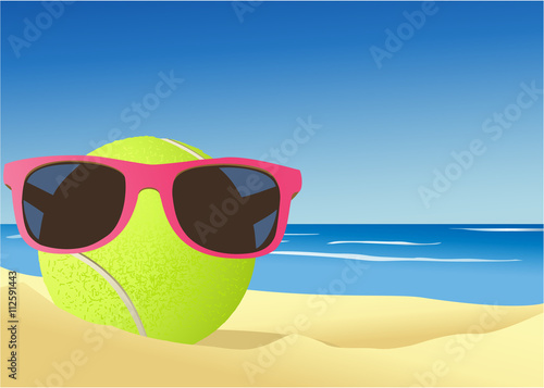 Tennis ball on the beach sand © czibo