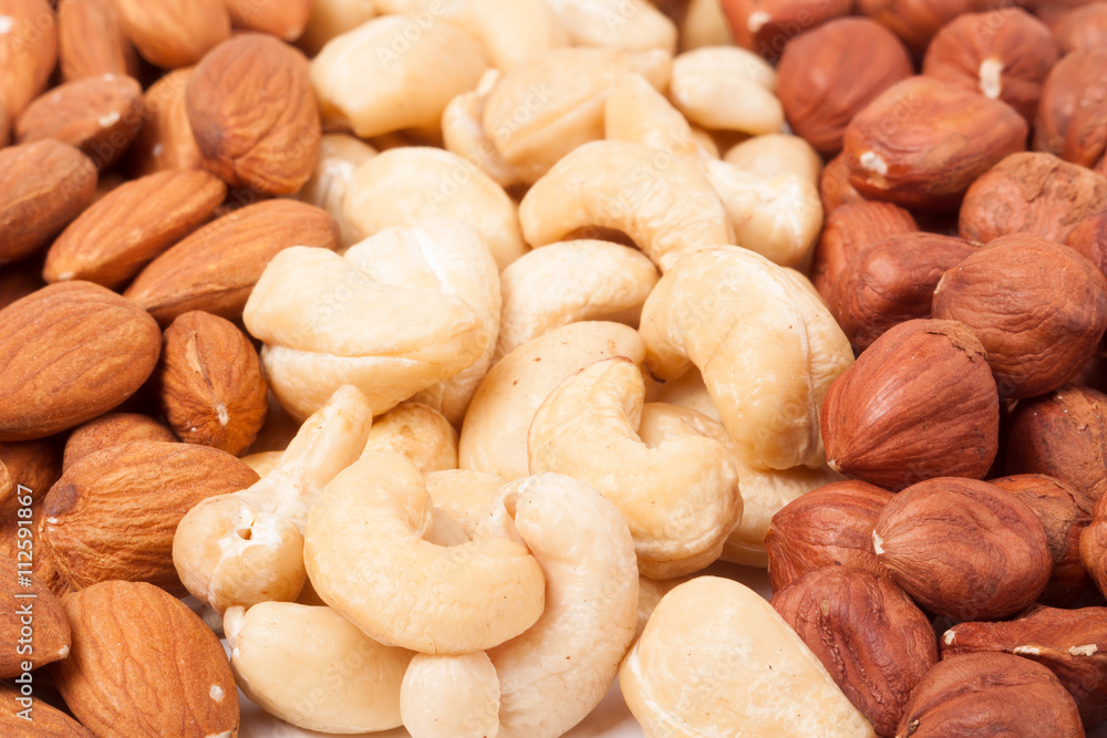 almonds cashews and hazelnuts peeled as background almonds cashews and hazelnuts peeled as background