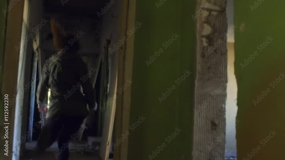 The girl run away from killer in abandoned building through the hallway. Back view horror dark mood. Steadicam shot. Smooth tracking. Old abandoned place. Super Slow motion. The girl run away from killer in abandoned building through the hallway. Back view horror dark mood. Steadicam shot. Smooth tracking. Old abandoned place. Super Slow motion.