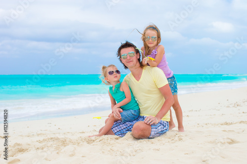 Happy family on tropical beach having fun together
