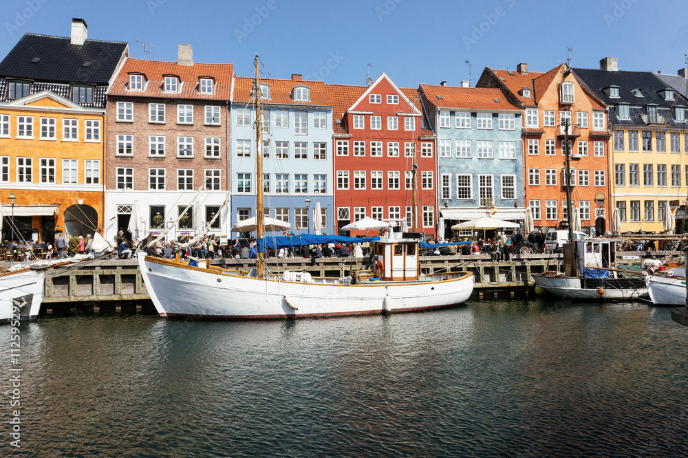 Scenic water front view of Nyhavn colorful buildings at sunny summer day in Copehnagen, Denmark