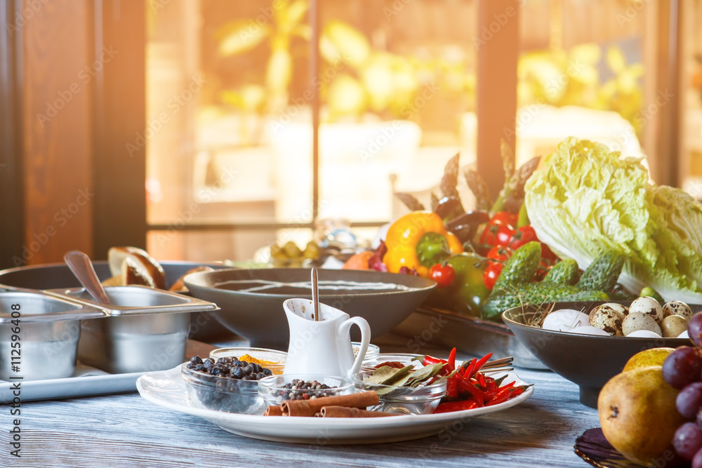 Cucumber and paprika with tomatoes. Plate with spices beside vegetables. Hearty vegetarian meal. Morning in cafe kitchen. Cucumber and paprika with tomatoes. Plate with spices beside vegetables. Hearty vegetarian meal. Morning in cafe kitchen.
