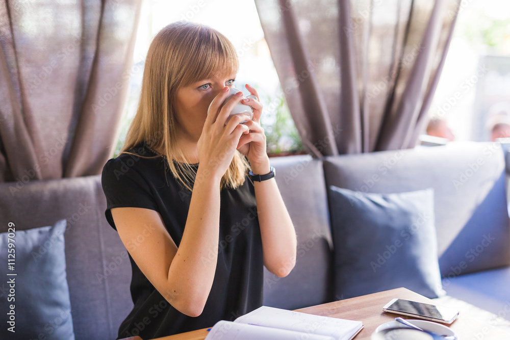 beautiful young woman while drinking tea beautiful young woman while drinking tea